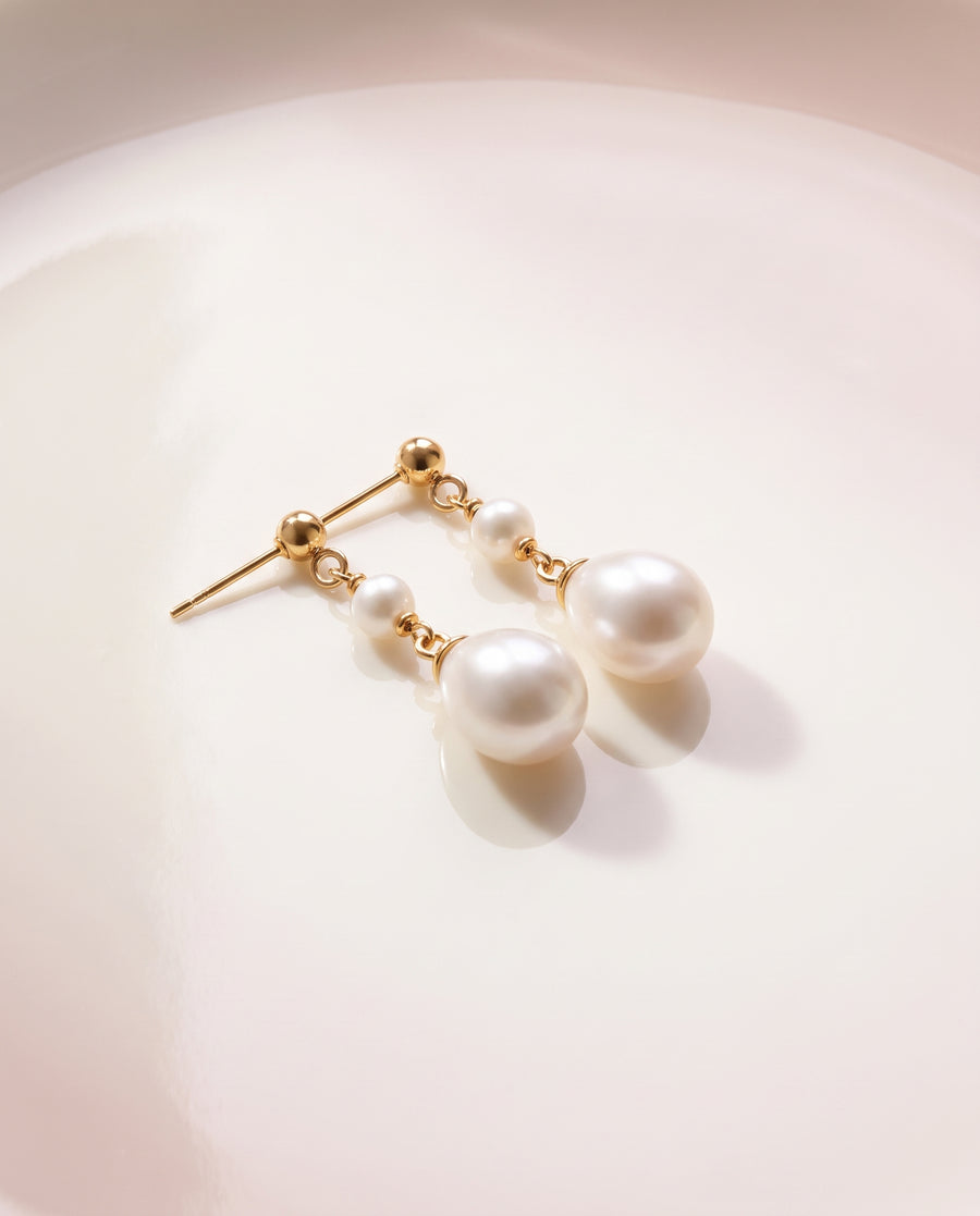 Fine Chain Pearl Drops freshwater pearl earring on a glossy pedestal