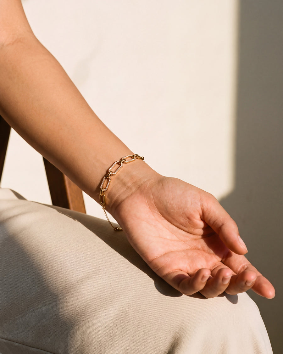 Pave link bracelet worn on the wrist, hand resting relaxed