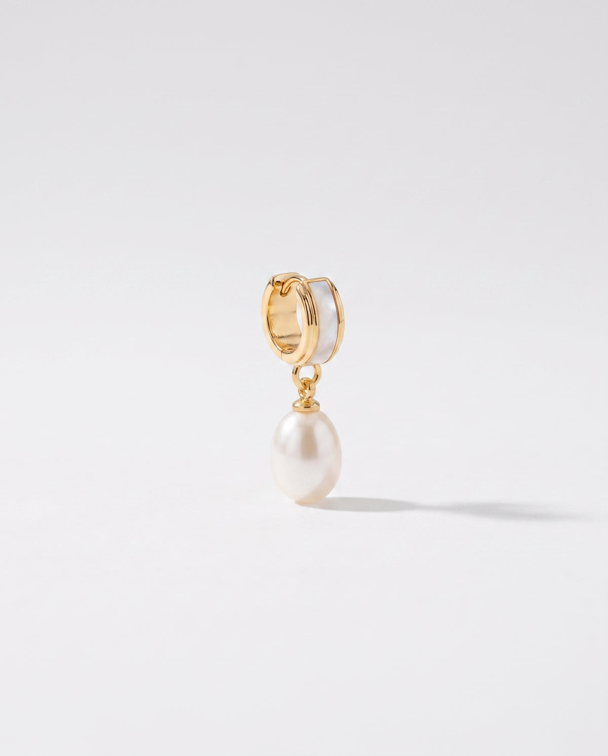 Shell Inlay Pearl Huggie Drops freshwater pearl earring on a clean white background