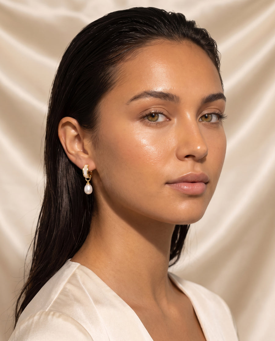 Shell Inlay Pearl Huggie Drops freshwater pearl earring editorial portrait on champagne silk