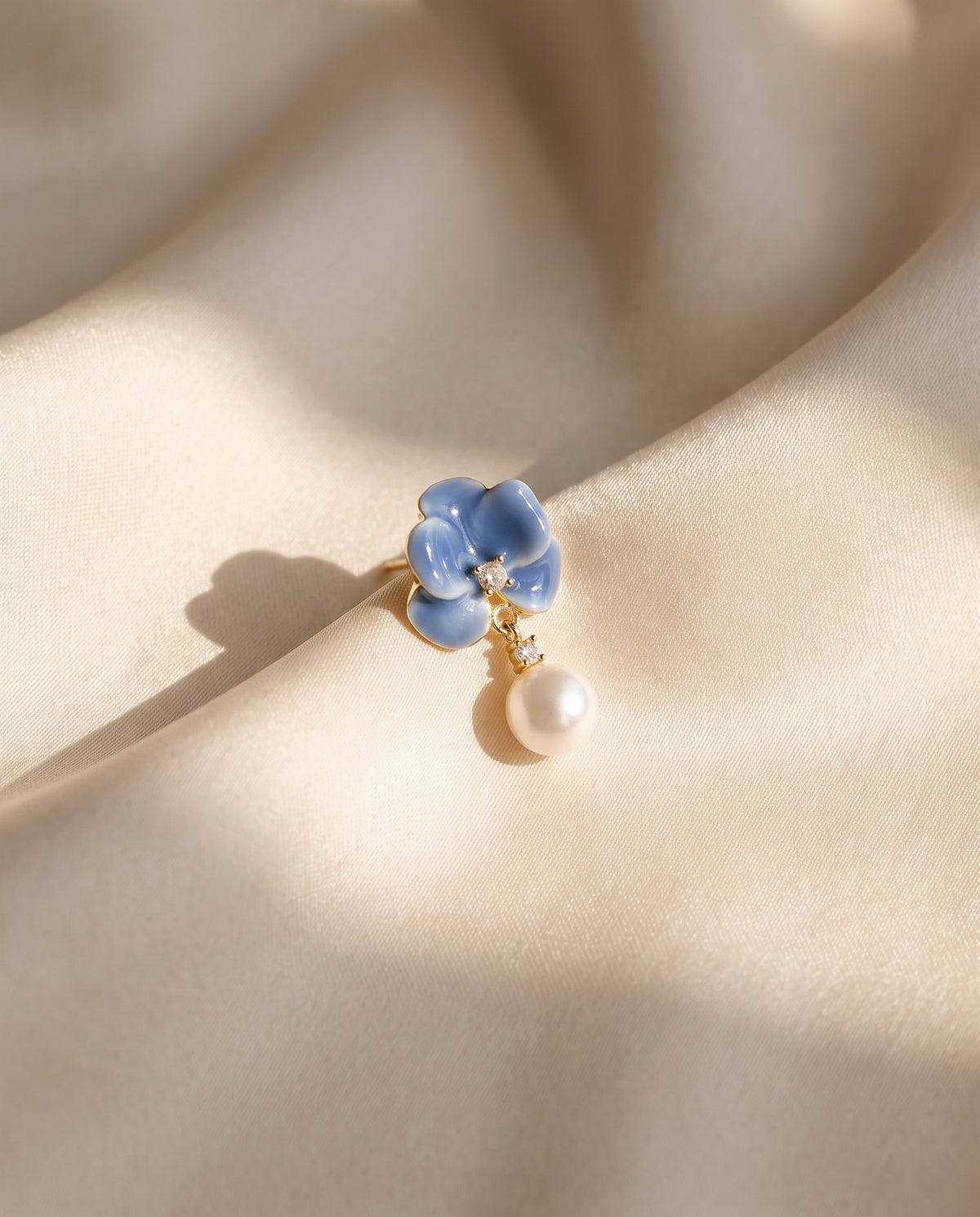 Blue Enamel Bloom Pearl Drops freshwater pearl earring draped on champagne ivory silk