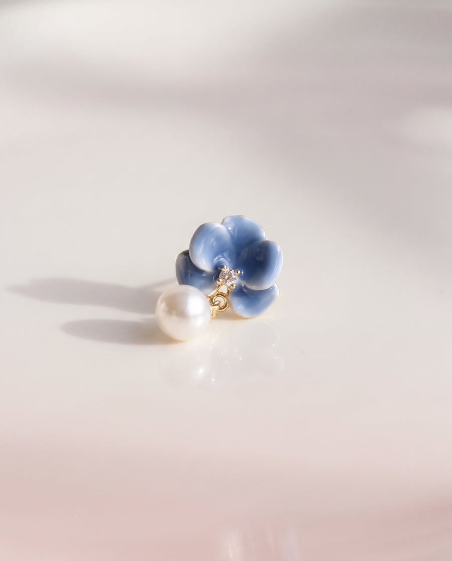 Blue Enamel Bloom Pearl Drops freshwater pearl earring on a glossy pedestal with soft reflection