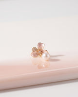 Blush Enamel Bloom Pearl Drops freshwater pearl earring on a glossy pedestal with soft reflection