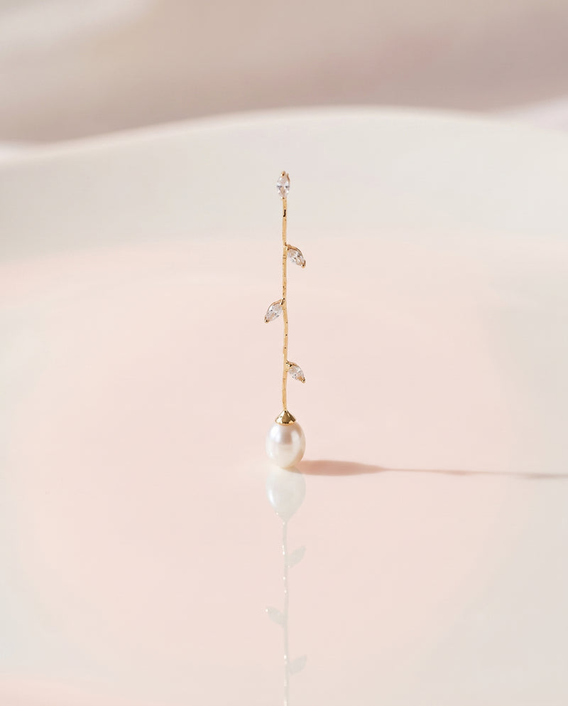 Gold Vine Pearl Drops freshwater pearl earring on a glossy pedestal with soft reflection