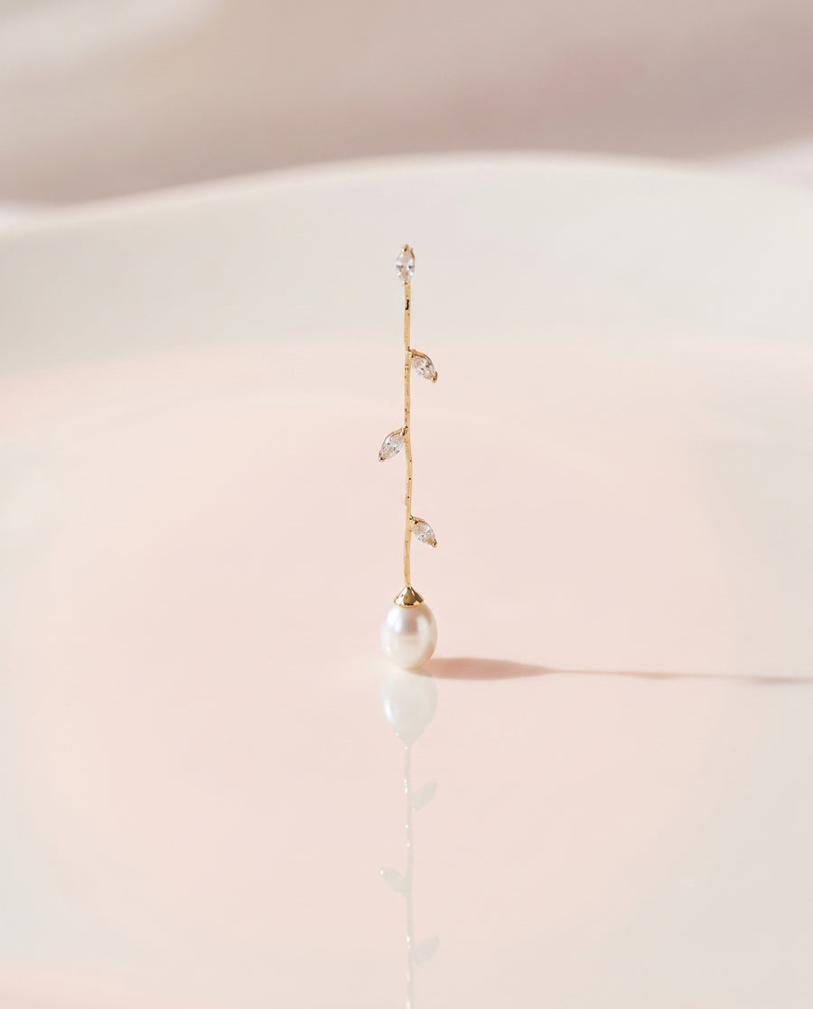 Gold Vine Pearl Drops freshwater pearl earring on a glossy pedestal with soft reflection
