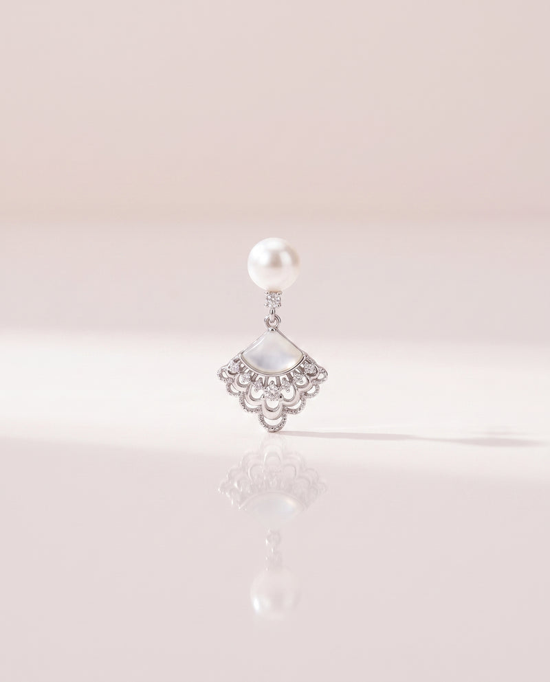 Fan Shell Pearl Drops freshwater pearl earring on a glossy pedestal with soft reflection