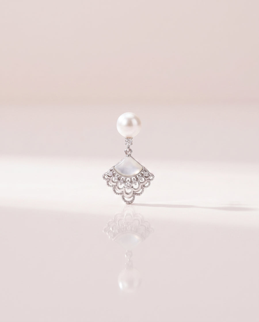 Fan Shell Pearl Drops freshwater pearl earring on a glossy pedestal with soft reflection
