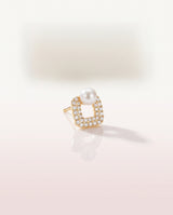 Square Pave Pearl Studs freshwater pearl earring on a glossy pedestal