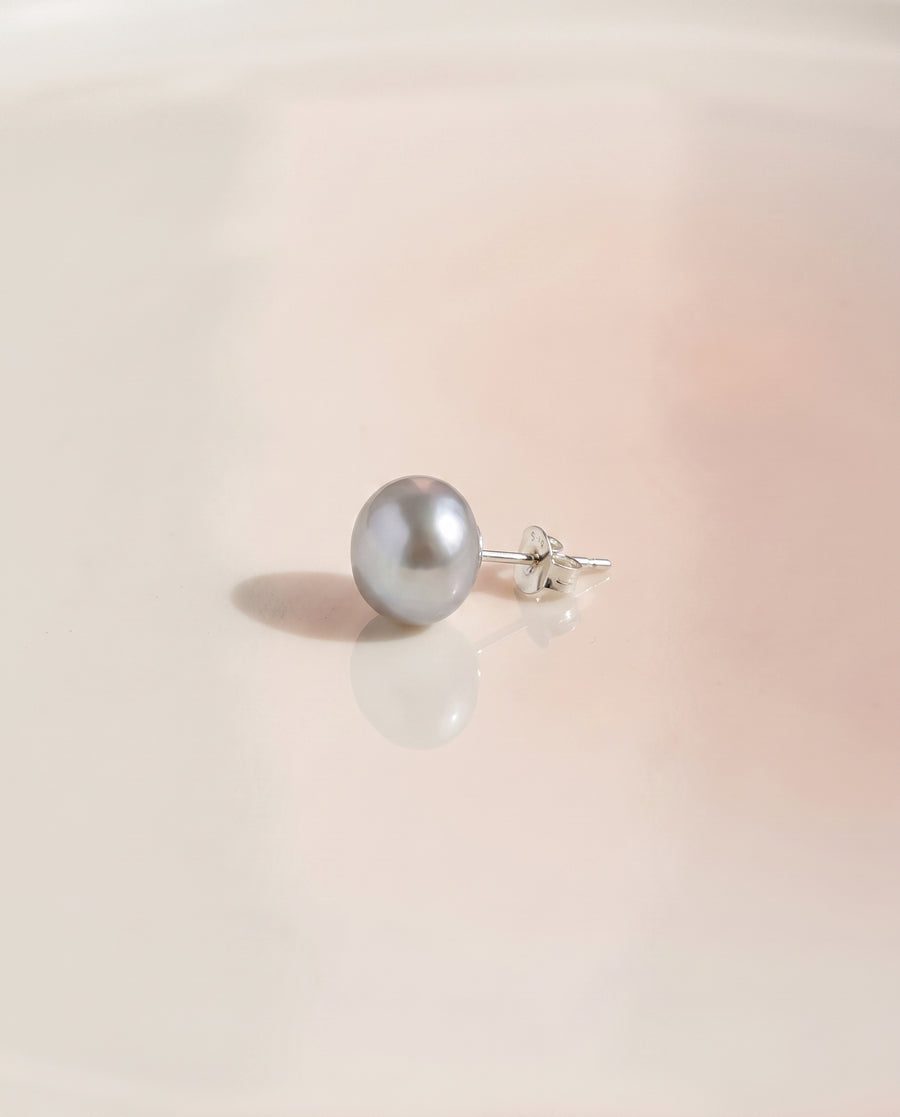 Grey Baroque Pearl Studs freshwater pearl earring on a glossy pedestal
