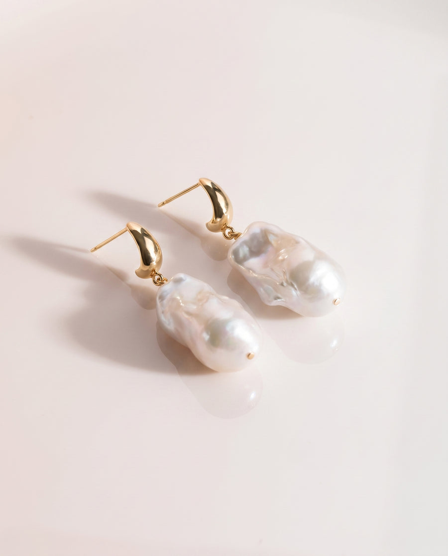 Baroque Pearl Drop Earrings freshwater pearl earring on a glossy pedestal