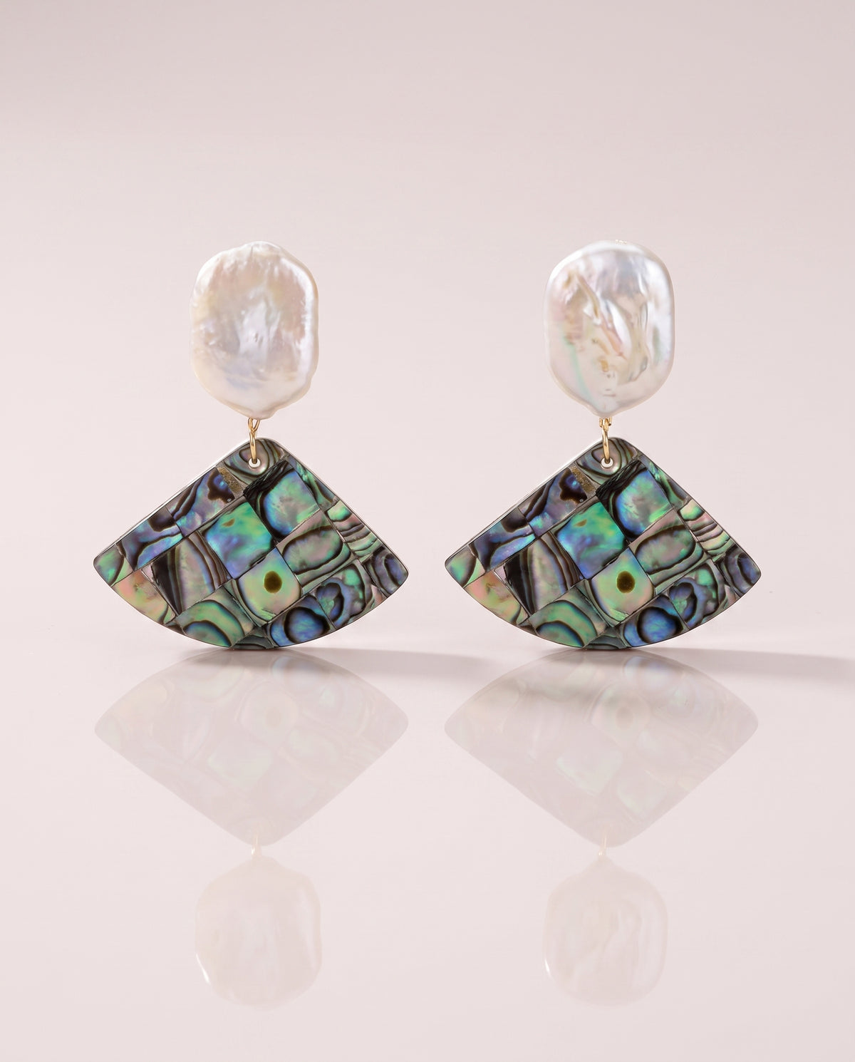 Abalone Shell Fan Drops freshwater pearl earring on a glossy pedestal