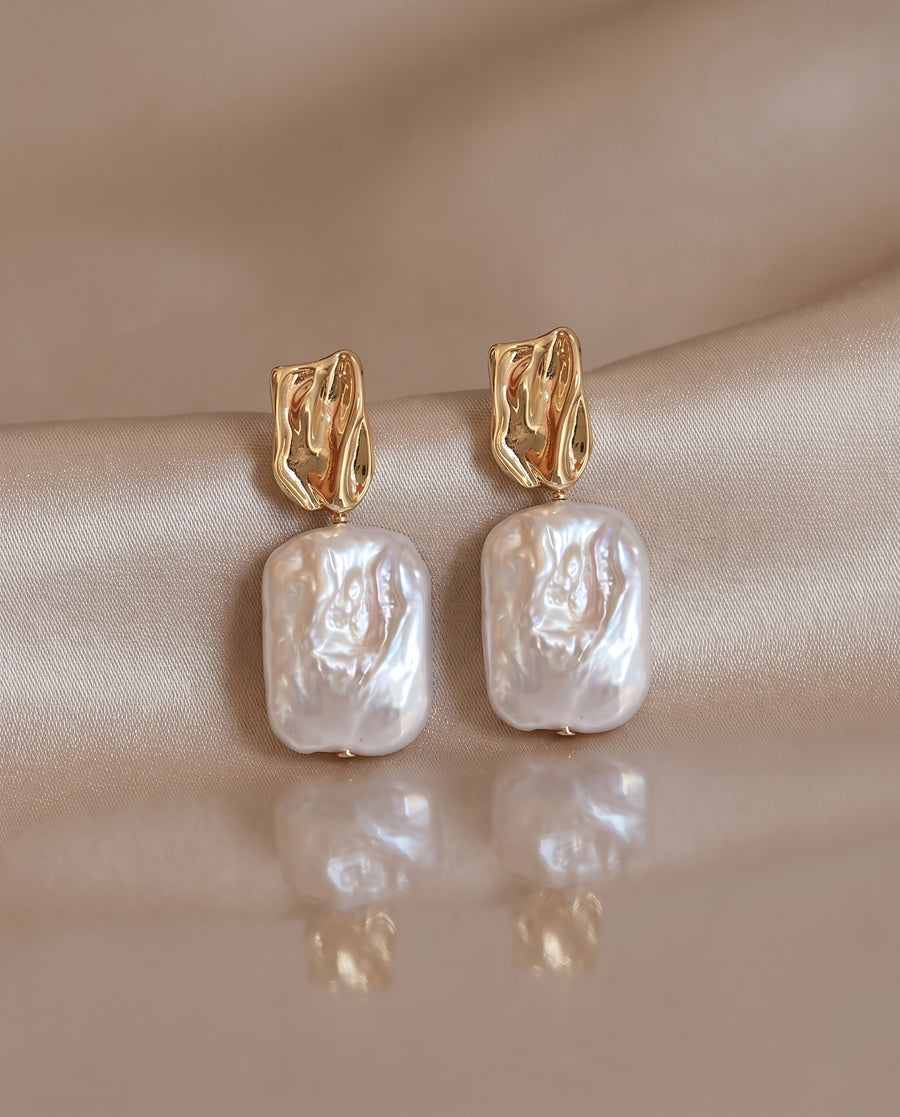 Rectangle Baroque Pearl Drops freshwater pearl earring on a glossy pedestal