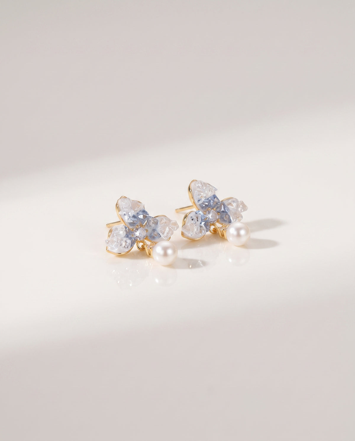 Blue Petal Pearl Studs freshwater pearl earring on a glossy pedestal