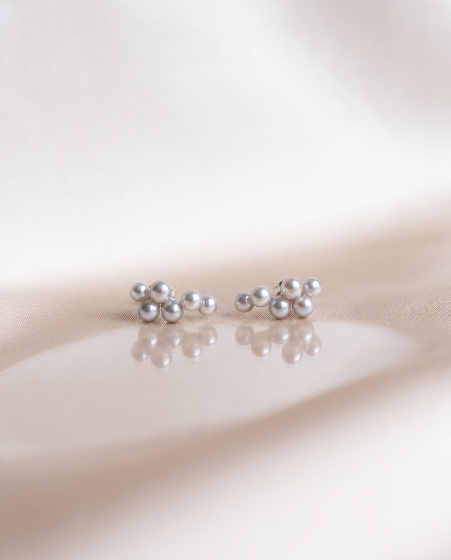 Grey Pearl Climber Studs freshwater pearl earring on a glossy pedestal