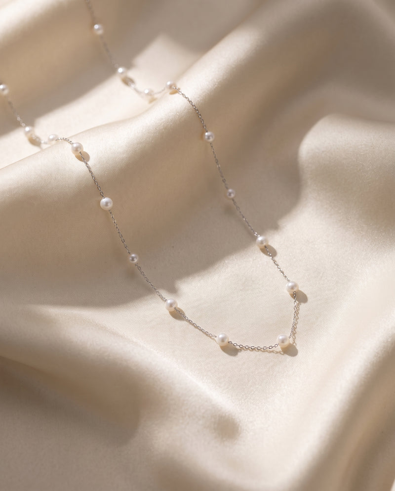 Pearl Station Necklace freshwater pearl necklace draped on champagne silk