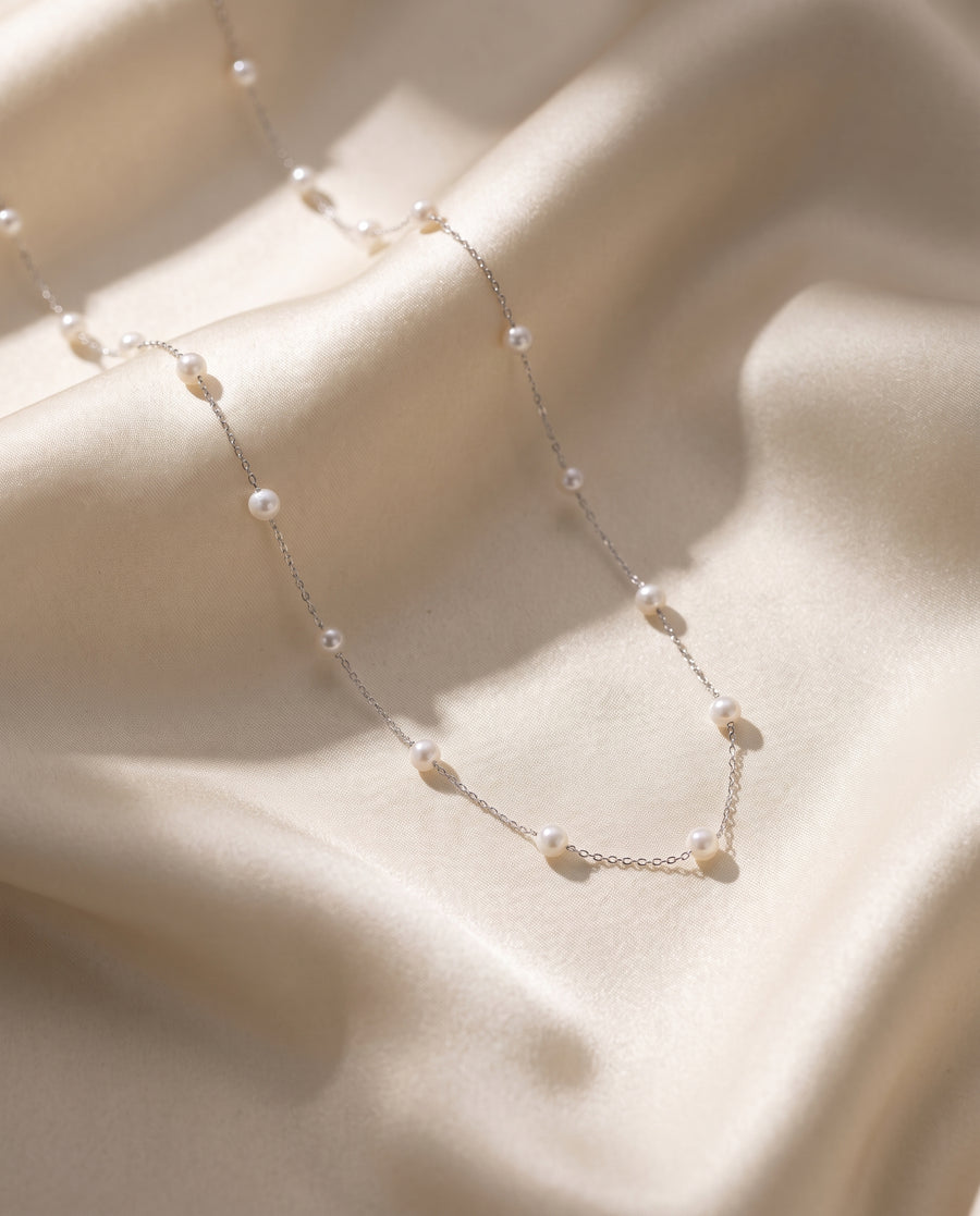 Pearl Station Necklace freshwater pearl necklace draped on champagne silk