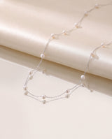 Pearl Station Necklace freshwater pearl necklace on a glossy pedestal
