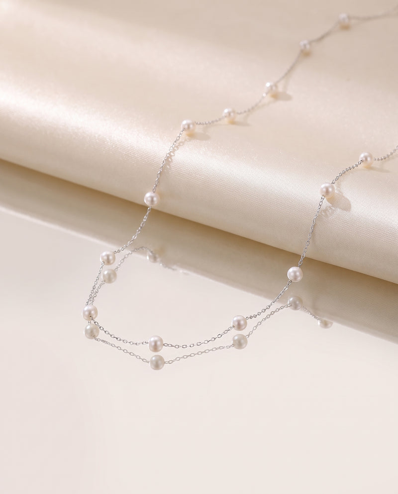 Pearl Station Necklace freshwater pearl necklace on a glossy pedestal