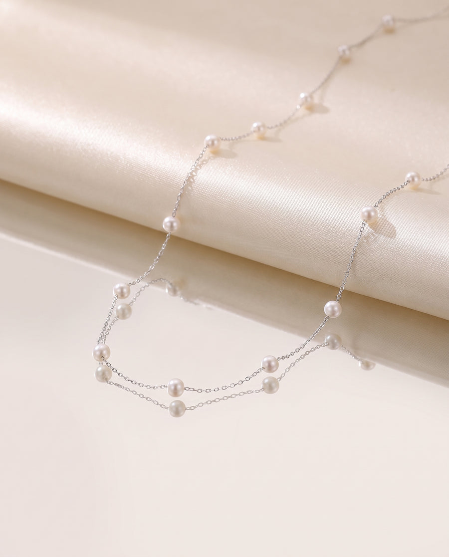 Pearl Station Necklace freshwater pearl necklace on a glossy pedestal