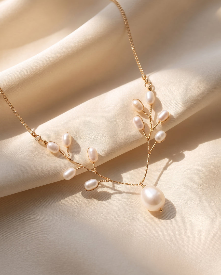 Pearl Vine Necklace draped on champagne silk