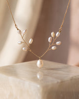 Pearl Vine Necklace on a glossy pedestal